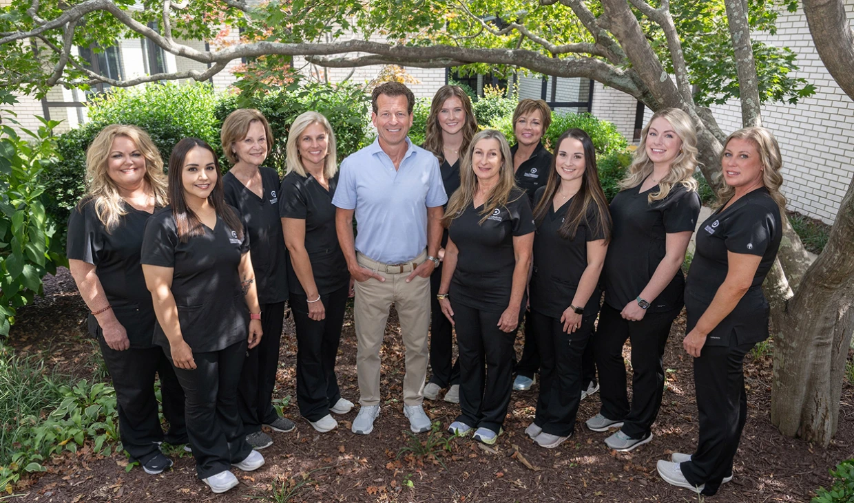The Potts Orthodontics team smiling together in the office